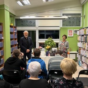 kobieta i mężczyzna stoją naprzeciwko grupy ludzi