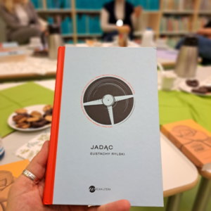 zdjęcie książki na tle półek z książkami