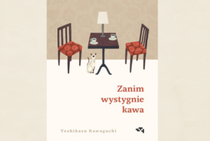 okładka książki a na niej stolik, lampka i dwie kawy, dwa krzesła, a na podłodze kot