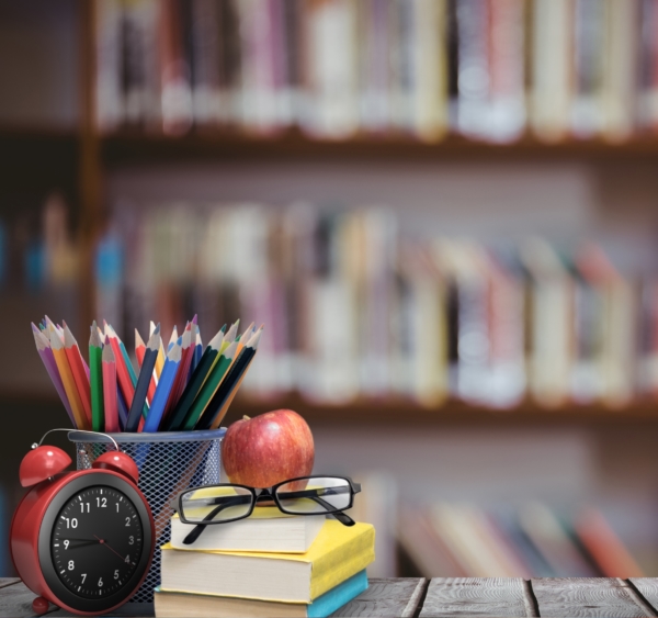 digital composite of School materials and apple with library background
