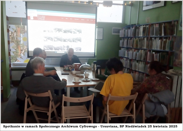 ursuviana_spotkanie Grupa ludzi siedzących przy stole. w tle wyświetlona na ekranie prezentacja.